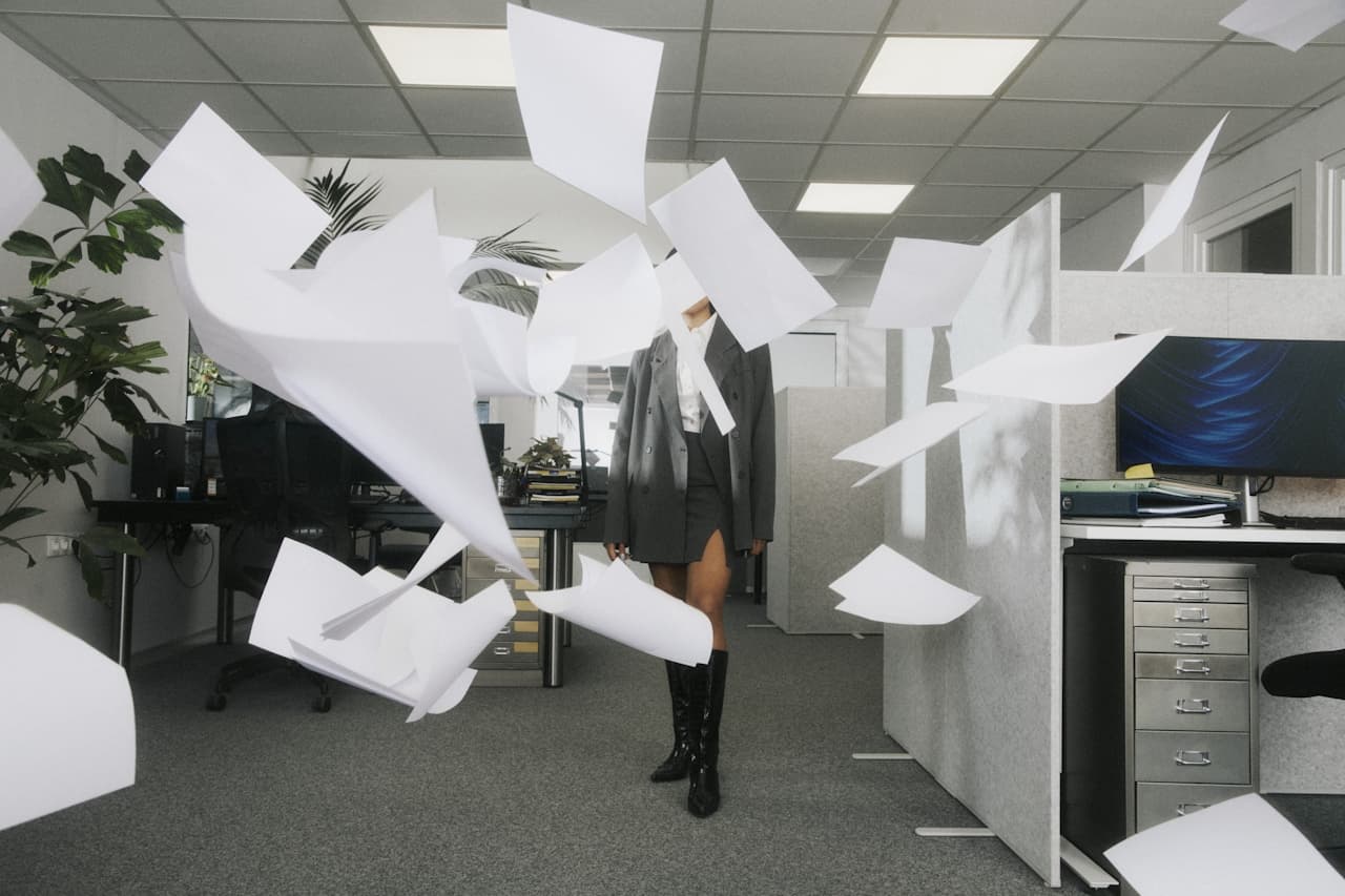 Papers flying in office — the chaos before systems